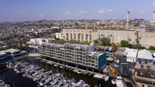 Aerial close-up panning shot of the leasing apartments at King Harbor Marina in Redondo Beach, California. 4K