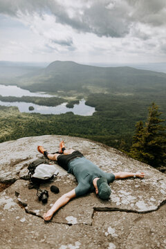 exhausted hiker takes break at viewpoint in Maine, Appalachian Trail