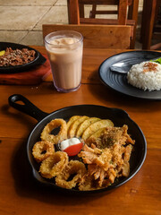 Snacks on plate, onion rings, potatoes and crispy mushrooms 
