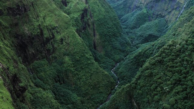 Teahupoo, Tahiti aerial drone view of the river in the valley of mountain Orohena Aorai Ronui. French Polynesia. Paradise in Pacific Ocean. Moana Disney's inspiration for Te Fiti. 2024 Paris Olympics.