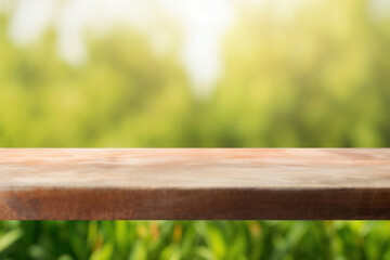 Empty wooden table top with blurred green garden background