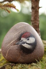 Stone painting of great spotted woodpecker