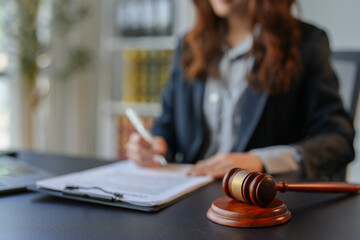 Lawyer women holding pen with contract or agreement document to the customer for signing in courtroom legal, Sign a contract business.