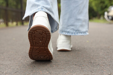 Woman going along road, closeup. Concept of new beginning