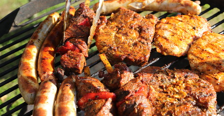 various meat and sausages on the charcoal grill