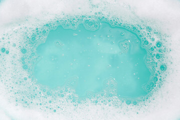 Detergent foam bubble on water. Blue background, Soap sud