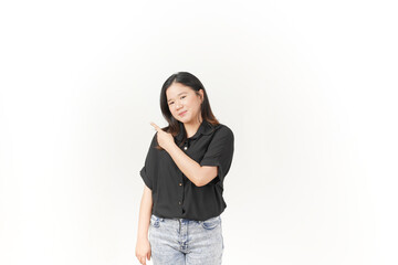 Young Asian woman presenting and pointing side copyspace wearing Black t-shirt and jeans isolated on white background