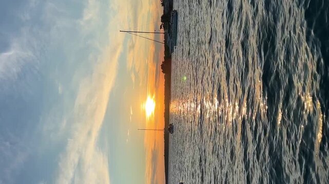 Yachts moored on buoys near the shore in the bay of Uvala Gradina near the town of Vela Luka on the island of Korcula at sunset lights in Croatia
