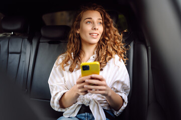 Woman with seat belt using phone inside car. Concept of technology, traveling by car, business.