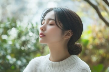 Naklejka premium Portrait conceptual photography of a Japanese woman in a white sweater, looking peaceful and meditative outdoors, surrounded by greenery, High-resolution, detailed textures, crisp focus