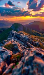 Obraz premium A view of a sunset over a mountain range from the top of a mountain