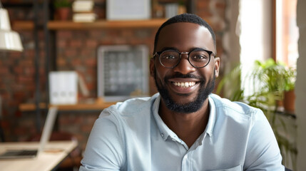 Happy office employees working at a desk and talking on a video conference. African Americans sitting at a modern office desk. Internet work concept. Lifestyle.