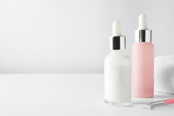 Bottles of chemical peel and brush on light background, space for text. Peeling procedure