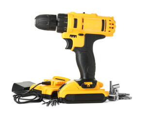 Modern cordless electric screwdriver, drill bits, charger and battery isolated on white