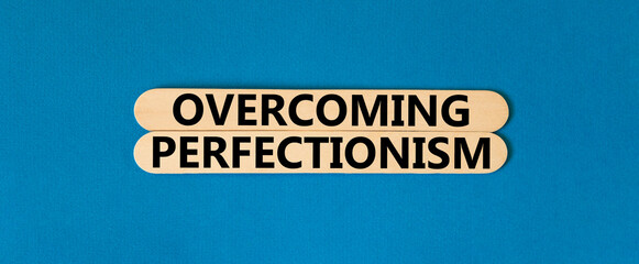 Overcoming perfectionism symbol. Concept words Overcoming perfectionism on beautiful wooden stick....