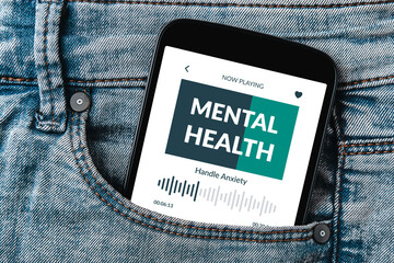 Meditation app displayed on a smartphone screen peeking out of a jeans pocket. Mental health app concept.