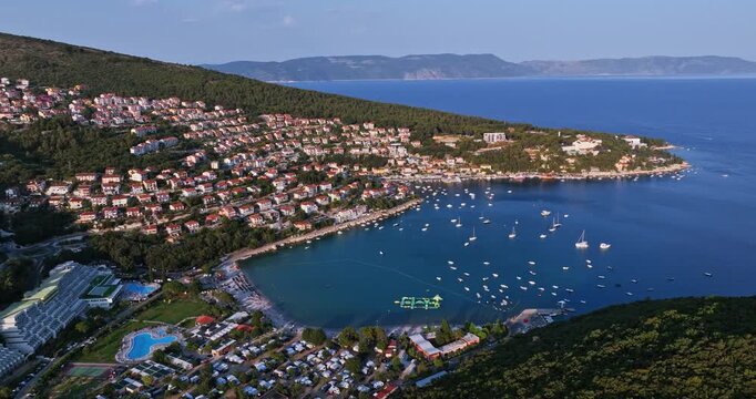Panoramic drone shot of vacation homes and boats in the bay of Rabac, Croatia