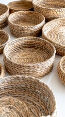 Obraz premium Handcrafted Woven Baskets Displayed on a Light Surface in a Sunlit Craft Studio