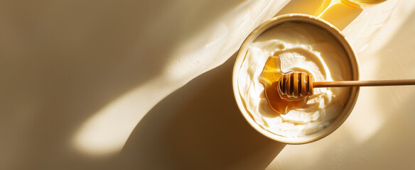 top view of honey drizzled on Greek yogurt in an empty bowl, with sunlight casting soft shadows and highlighting the natural beauty of both ingredients