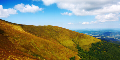 Fototapeta premium scenery with grassy slopes of borzhava ridge. magnificent carpathian mountain landscape in dappled light. beautiful view of transcarpathia highland in late summer