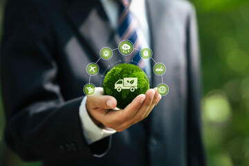 Green logistic or Sustainable transport concept. Businessman holding a globe with icon Global...