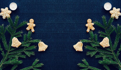 Gingerbread and Christmas tree branches on a dark paper craft background. Happy New Year Banner