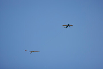 a small plane towing a glider for training.
