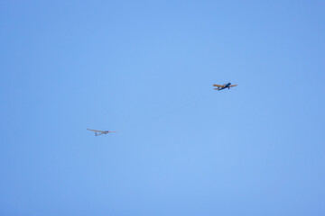 a small plane towing a glider for training.