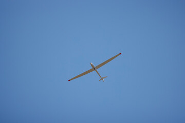 a glider flying in the blue sky