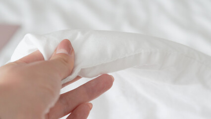 Smooth white bedsheet background, soft texture, clean and minimalist style.