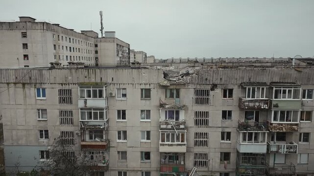 War in residential areas, broken windows and burned apartments. War in the city. City in war zone. Damage to a house as a result of artillery shelling. Armed conflict in Ukraine. High quality 4k