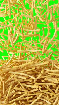 Fried potato chips falling down from above vertical green screen background. French fries falling down from top, fast food, junk food vertical chroma kay background.	