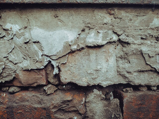 Red brick wall texture background with cement. Old grunge surface. Erosion concept.
