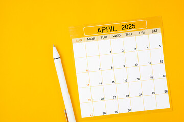 April 2025 Monthly calendar for 2025 year with pen on yellow background.