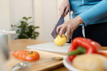 Healthy Lifestyle and Wellness Person Preparing Fresh Vegetables and Fruits in a Modern Kitchen