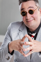 Sly salesman rubbing hands together devising scheme