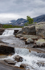 Small waterfall flowing over stones in the mountains of Rago, Northern Norway