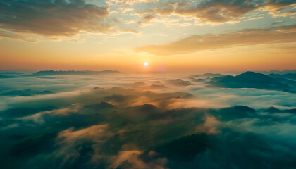 Fototapeta premium Aerial view of breathtaking sunrise over misty landscape with rolling hills and verdant fields
