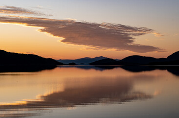 Orange and yellow evening lights on a beach in Northern Norway during the midnight sun