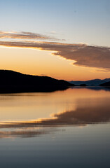 Fototapeta premium Orange and yellow evening lights on a beach in Northern Norway during the midnight sun