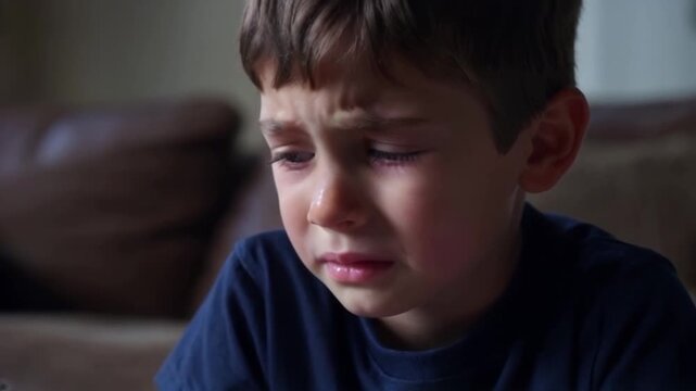 Sad boy close-up, portrait of tearful male person in living room, feeling sorrow and despair, depressed mood