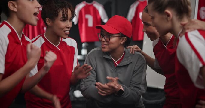Woman, coach and huddle for football, motivation and team with cheers, applause and support in locker room. People, manager and soccer group, sports and diversity with encouragement for competition