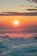 Sea of clouds at dramatic colorful evening sky during the midnight sun in the Lofoten, Northern...