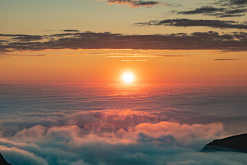 Sea of clouds at dramatic colorful evening sky during the midnight sun in the Lofoten, Northern...