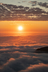 Sea of clouds at dramatic colorful evening sky during the midnight sun in the Lofoten, Northern...