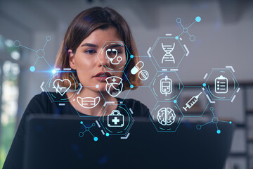 Woman with futuristic medical icons overlay on screen in office.