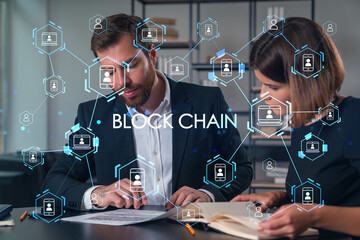 Business professionals discussing blockchain technology in the office.