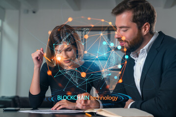 Business professionals discussing blockchain technology at office desk.