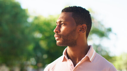Contemplative Man Gazing at Landscape in Sunny Outdoor Setting During Afternoon Hours