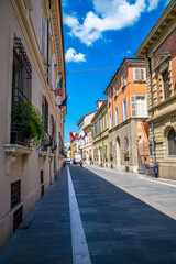 A view up a street leading away from Popolo square in Faenza, Italy  in summertime